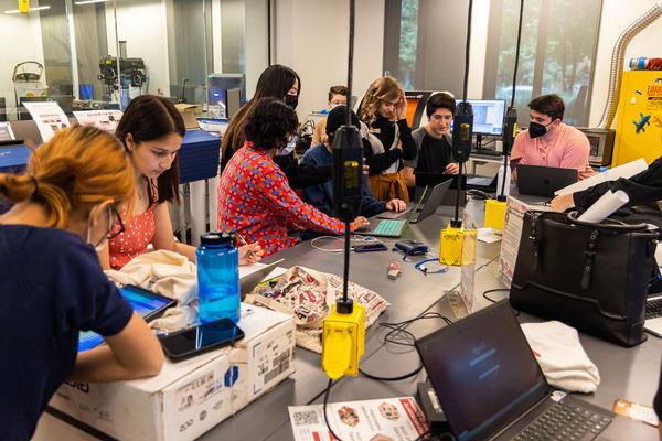 Two students work in an engineering classroom.