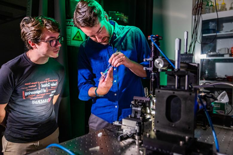 Professor and student in the optics lab